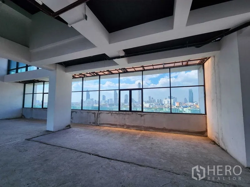 Retail Space for rent in Sathon, Bangkok - Long open retail floor with continuous windows, exposed services, and city outlook across Bangkok.