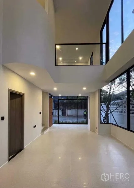 Home Office for sale in Lat Phrao, Bangkok - Open-plan ground floor with double-volume ceiling and large windows.
