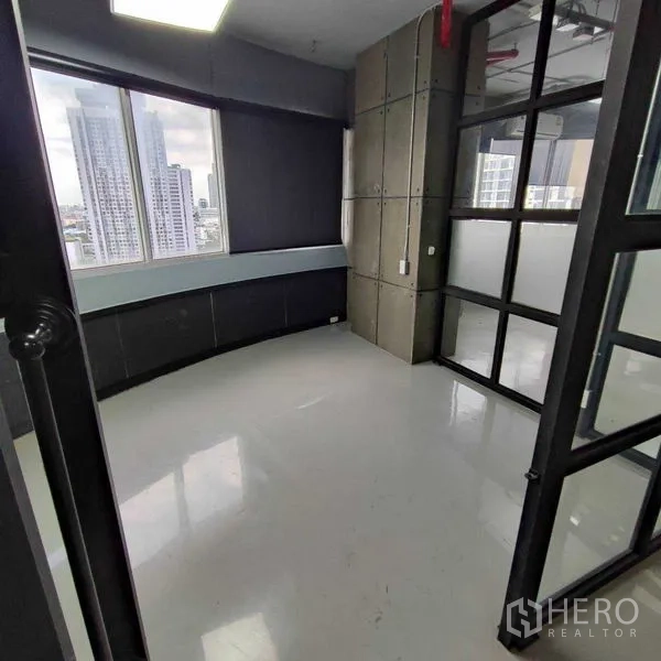 Office Space for rent in Watthana, Bangkok - Private office with curved window wall, skyline views and a black-framed glass door.