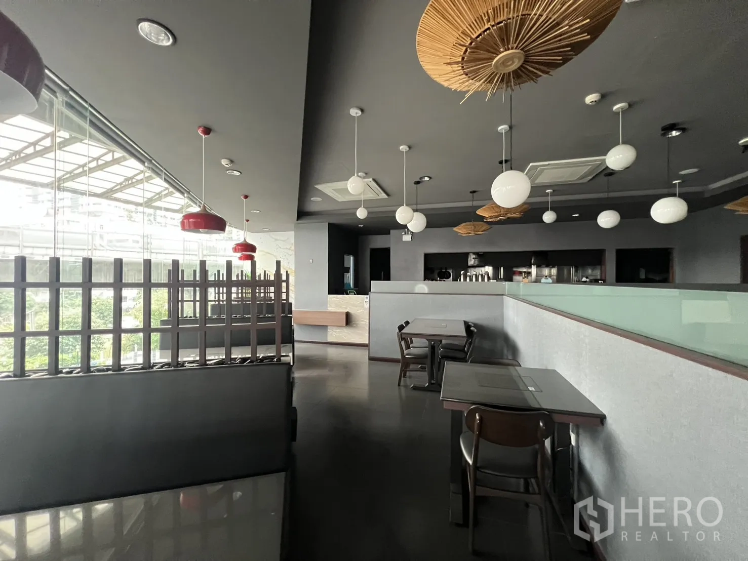 Retail Space for rent in Watthana, Bangkok - Retail unit featuring glass frontage, AC cassette ceilings, wooden accents, and tables overlooking greenery.
