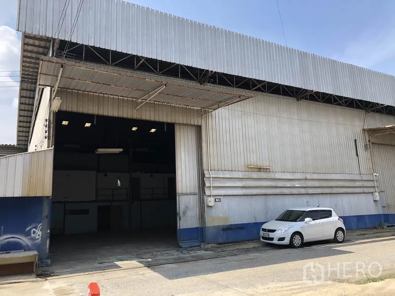 คลังสินค้า ให้เช่าในLam Luk Ka, Pathum Thani - ด้านหน้าโกดัง ช่องประตูเปิดกว้าง หลังคากันสาด พร้อมพื้นที่จอดรถ