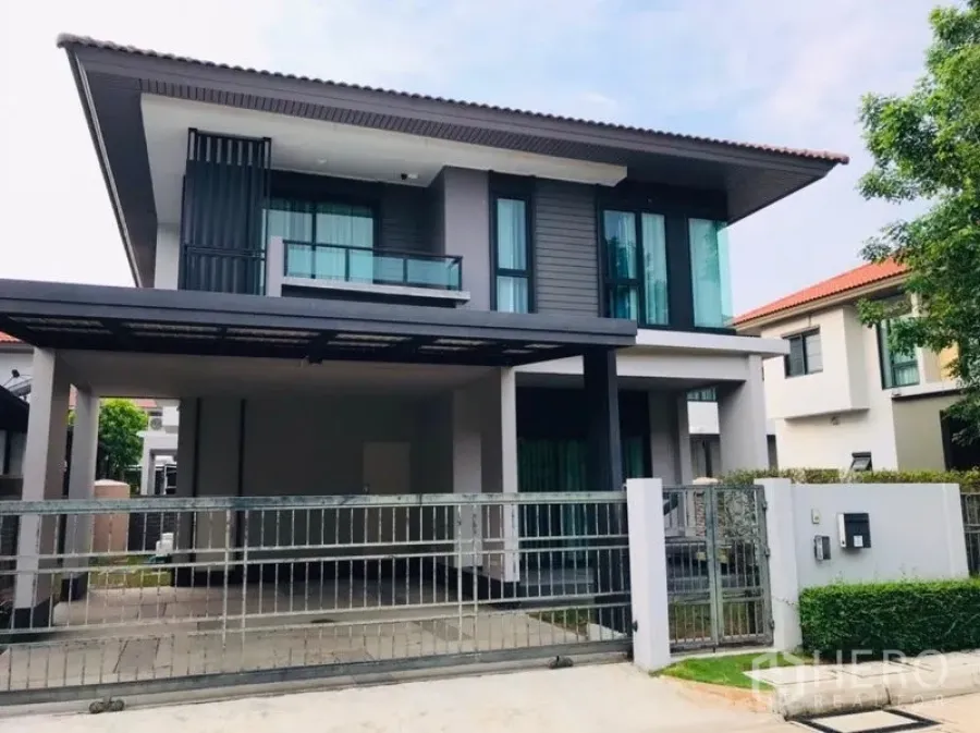 Detached House for rent or sale in Pathum Thani - Front facade of the house with sliding gate and double carport.