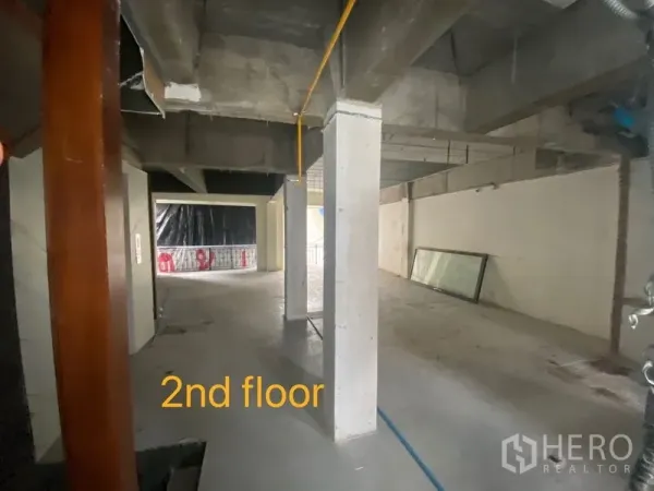 Shophouse for rent in Bang Rak, Bangkok - Second-floor open plan space with concrete columns and visible utility lines