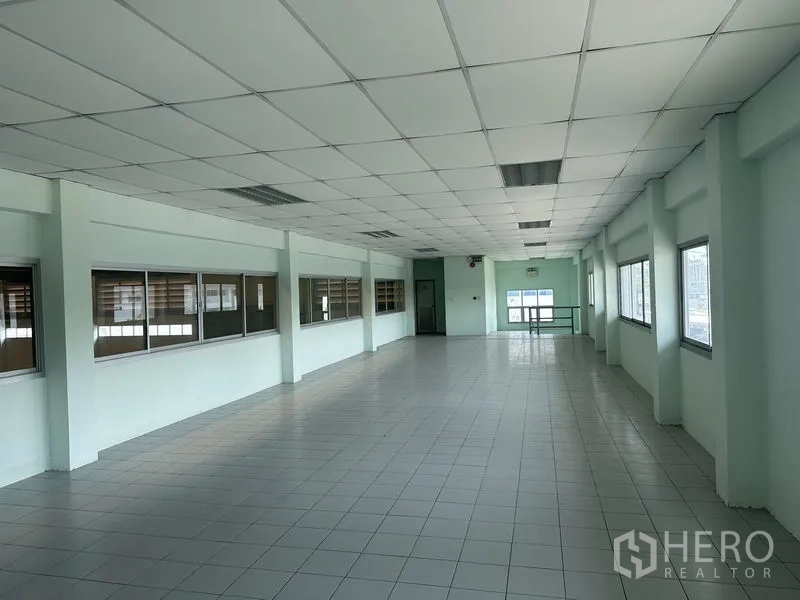 Factory for rent in Chon Buri - Office lobby with glass entrance doors, tiled floor and internal staircase to upper level.