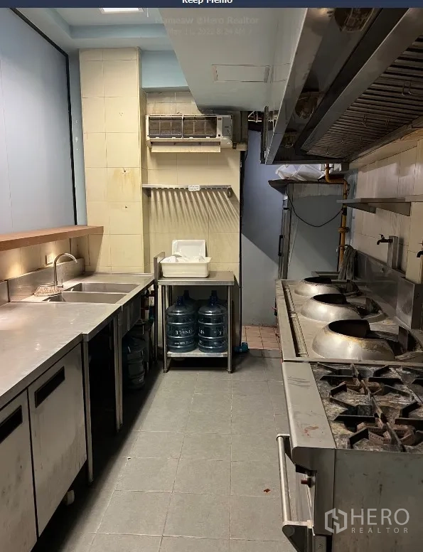 Retail Space for rent in Watthana, Bangkok - Commercial kitchen with stainless counters, sinks, gas stoves and exhaust hood.