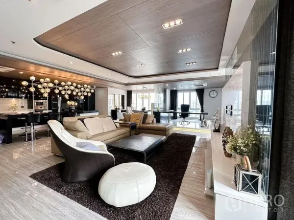 Condominium for rent or sale in Khlong Toei, Bangkok - Spacious living zone connecting to kitchen and home office with modern chandeliers.