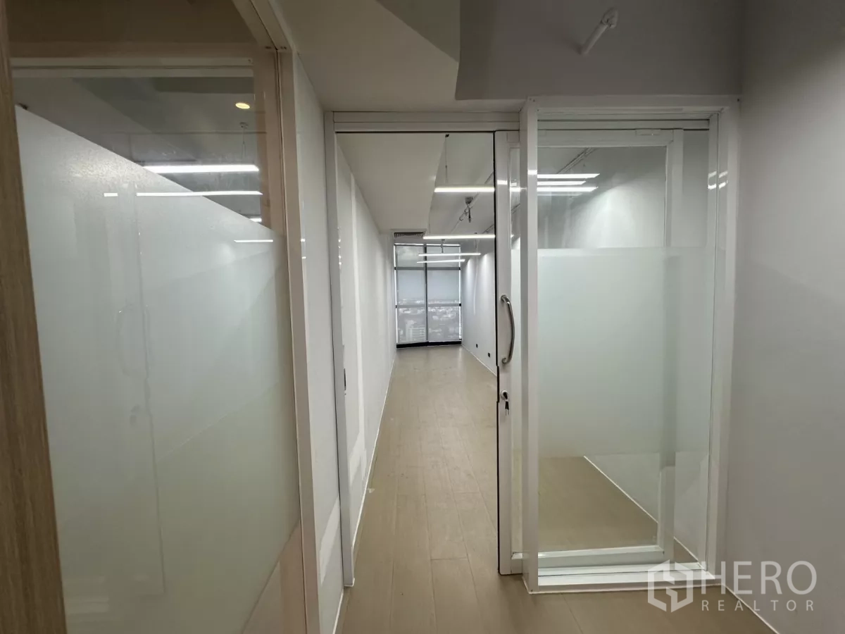 Office Space for rent in Watthana, Bangkok - Narrow glass corridor with sliding door and frosted panels.