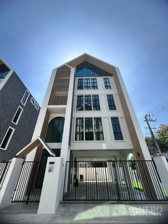 Home Office for rent in Bang Kapi, Bangkok - Contemporary gabled home office building with tall windows and secure front gate.