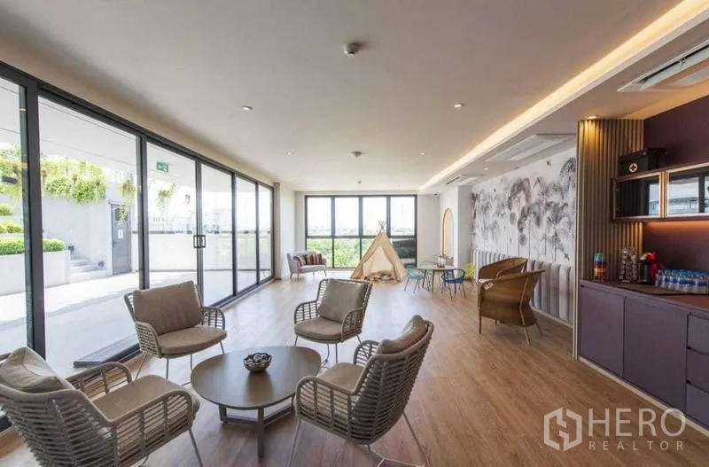 独立式住宅 出租或出售在Khan Na Yao, Bangkok - 社区会所休闲区，落地窗通向露台与绿化景观。