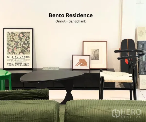 Townhouse for rent - Modern living area featuring a black coffee table, framed art and designer chairs.