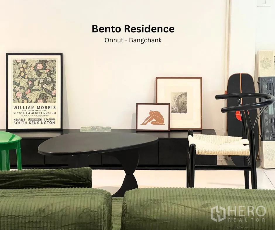 Townhouse for rent - Modern living area featuring a black coffee table, framed art and designer chairs.