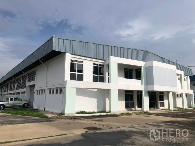 Factory for rent or sale in Bang Pa-in, Phra Nakhon Si Ayutthaya - Standalone factory with two-storey office wing, metal roof and wide driveway.
