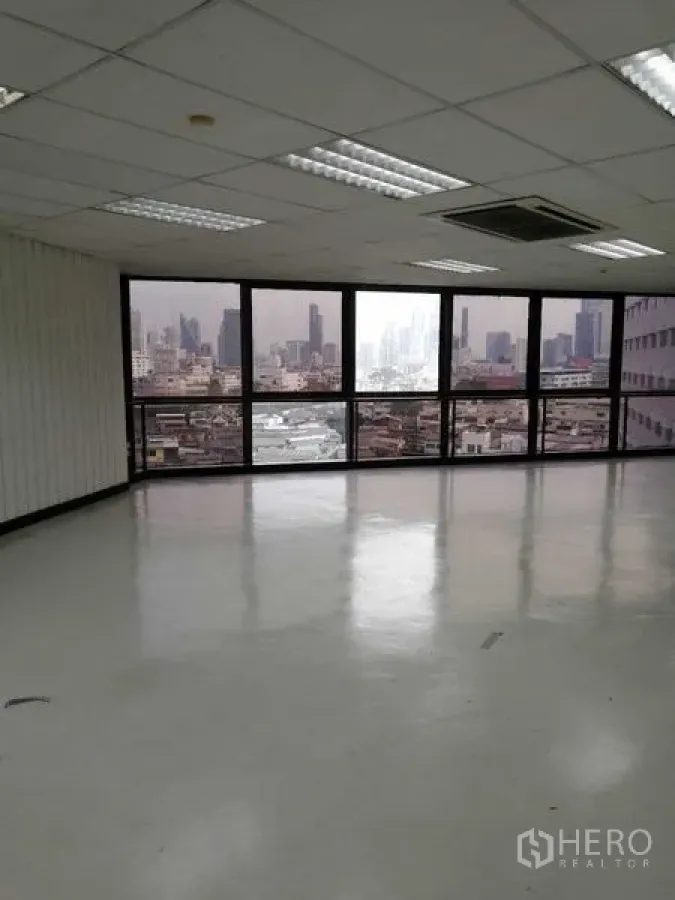 Office Space for rent in Bang Rak, Bangkok - Bright corner workspace with panoramic windows and urban cityscape.