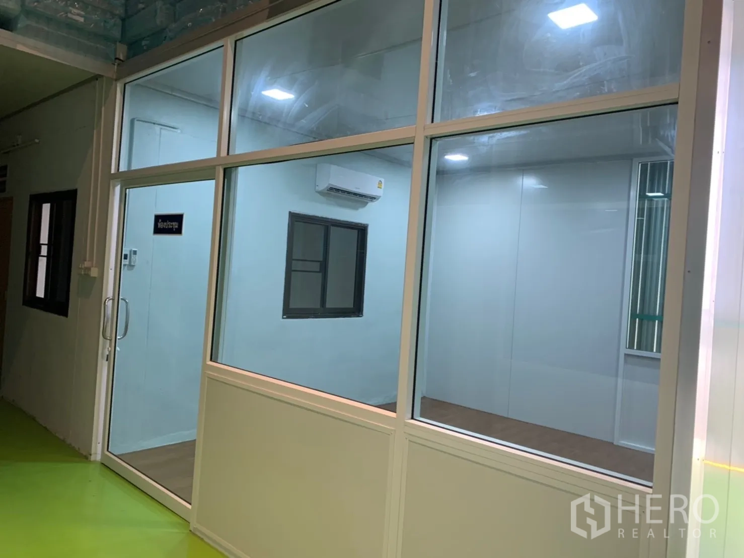 Factory for rent in Khlong Luang, Pathum Thani - Meeting or office room behind a glass wall with a split air conditioner.