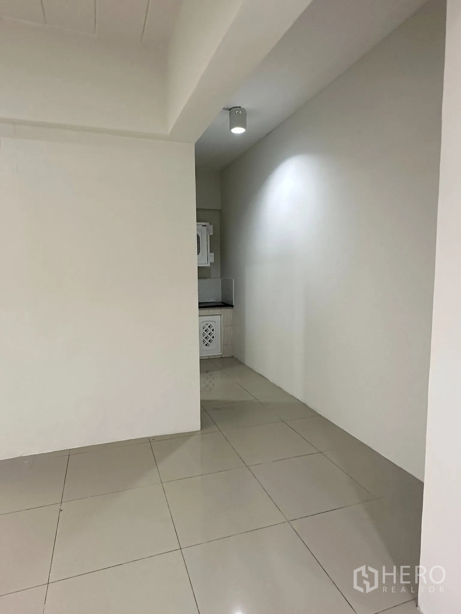 Office Space for rent in Watthana, Bangkok - View from the main floor toward the pantry alcove with ceiling light.