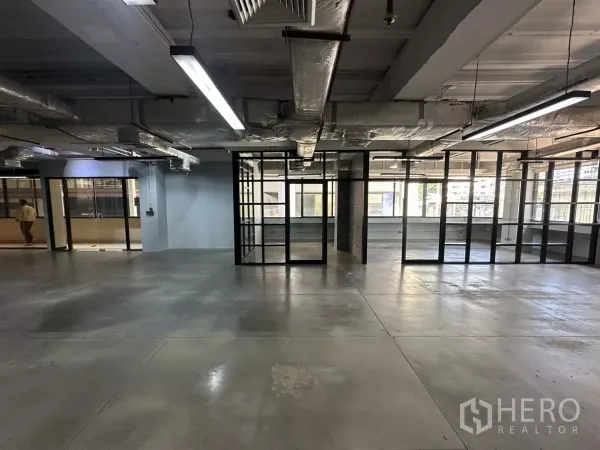 Office Space for rent - Central open area with multiple glass-walled rooms and natural light.