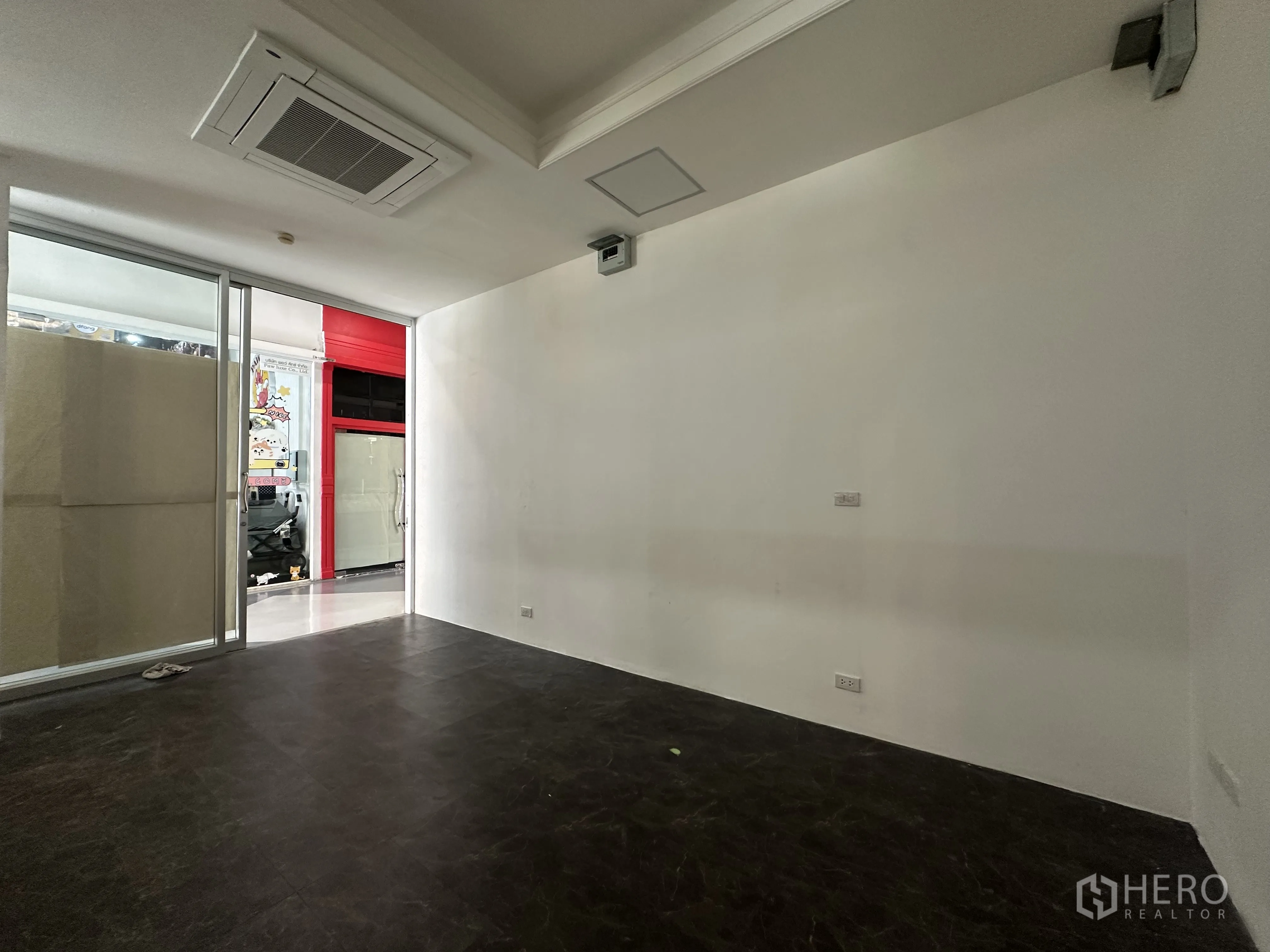 Retail Space for rent in Khlong Toei, Bangkok - Back corner of the unit with white walls, AC cassette, and view toward the retail corridor.