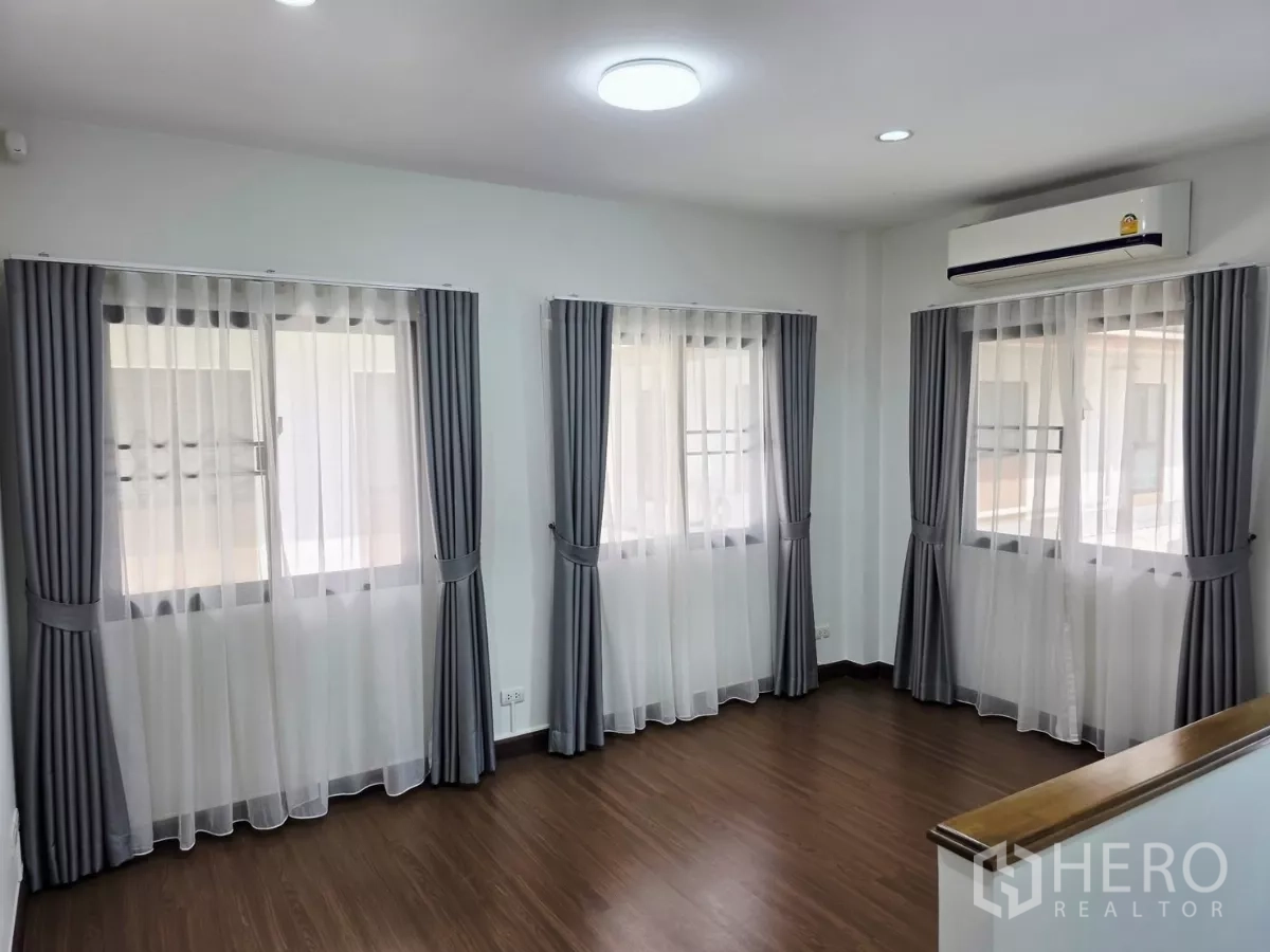 Detached House for rent in Prawet, Bangkok - Second-floor multipurpose room with three windows, wood flooring and air conditioning.