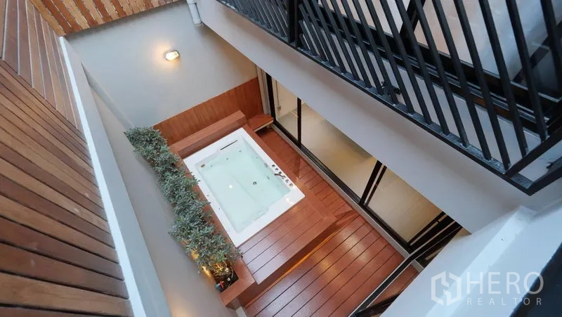 Townhouse for rent in Khlong Toei, Bangkok - Atrium courtyard viewed from above with a private jacuzzi set into a wooden deck.