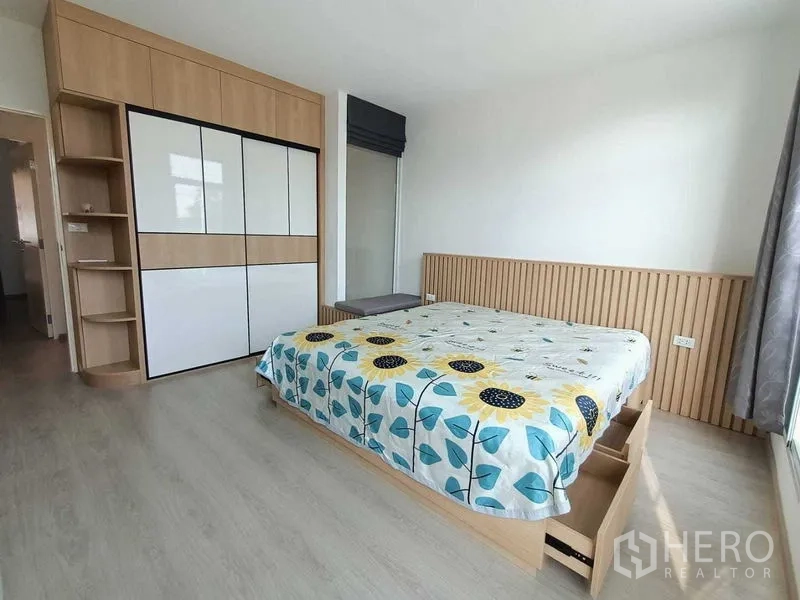 Townhouse for rent in Prawet, Bangkok - Master bedroom view highlighting storage bed, headboard detail and big windows.