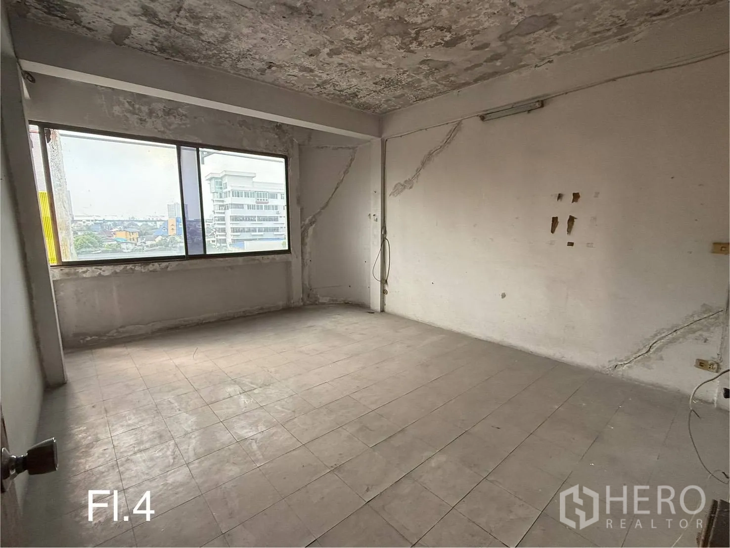 Shophouse for rent in Bang Na, Bangkok - Upper-floor room with city view through a wide window and tiled flooring.