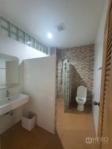 Home Office for rent or sale in Yan Nawa, Bangkok - Bathroom with vanity sink, walk-in shower and patterned tiles.