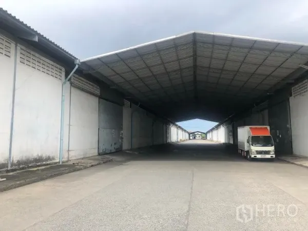 Warehouse for rent in Bang Pa-in, Phra Nakhon Si Ayutthaya - Covered loading bay between warehouses with truck access under a deep canopy.