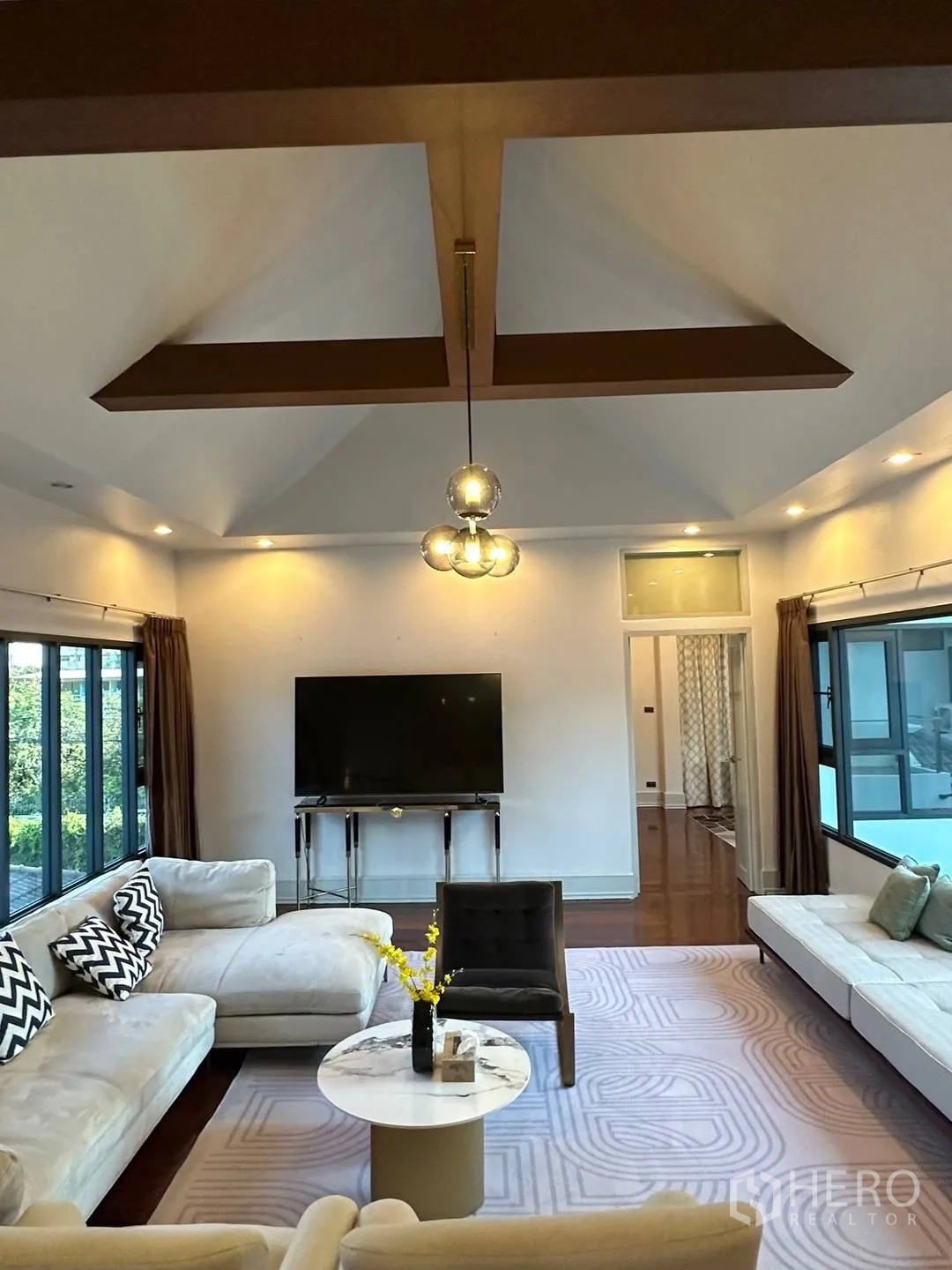 Detached House for rent in Watthana, Bangkok - Upstairs family room with sectional sofas, TV and coffered ceiling.