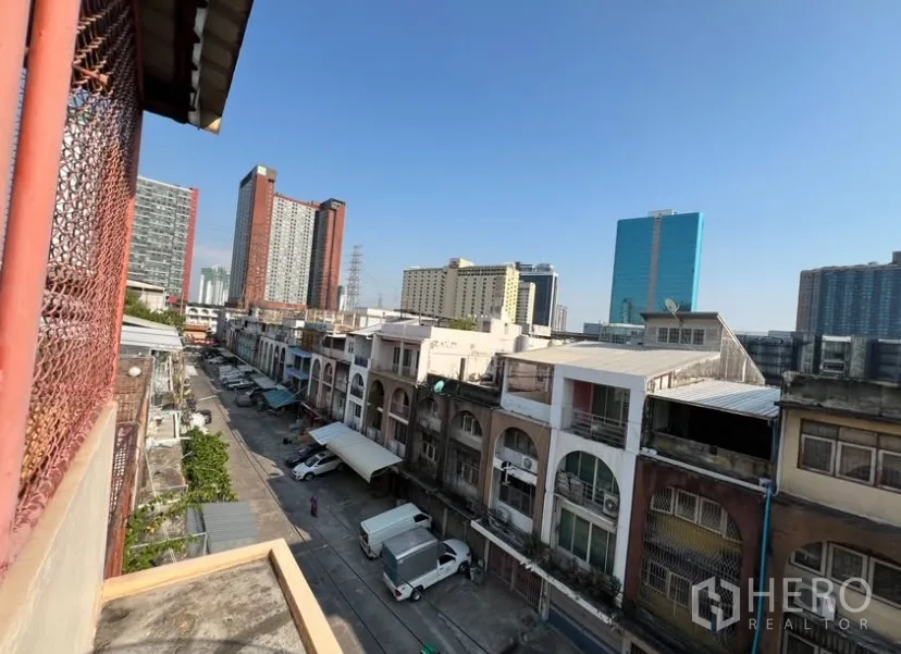 Shophouse for rent in Suan Luang, Bangkok - Upper terrace view over a row of shophouses and nearby high-rises.