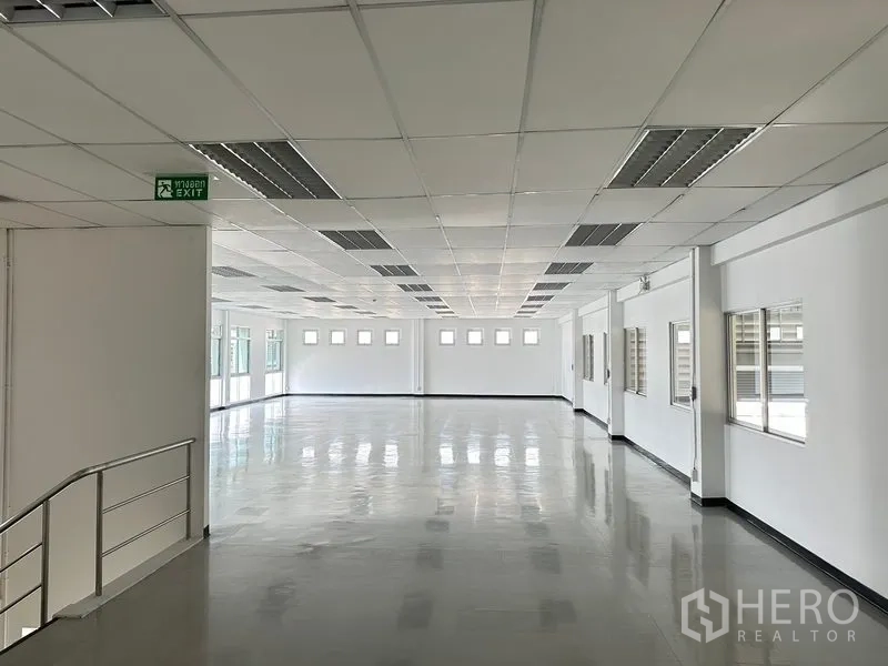 Factory for rent in Phra Nakhon Si Ayutthaya - Large open-plan second-floor office with drop ceiling, fluorescent lighting, and multiple windows.