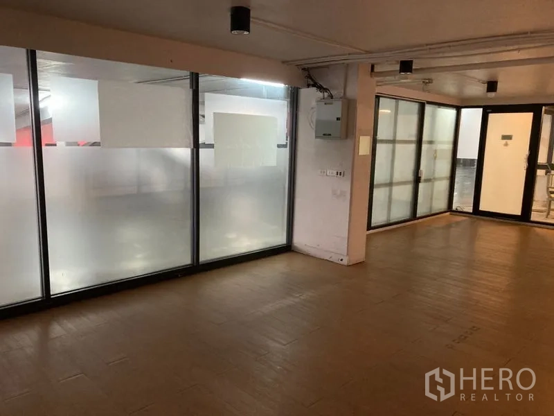 Retail Space for rent in Khlong Toei, Bangkok - Side wall with frosted glass panels, utility box, and a secondary entrance.