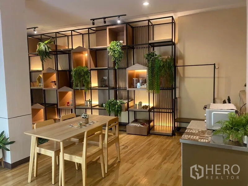 Retail Space for rent in Khlong Toei, Bangkok - Cozy retail corner with lit display shelves, wooden table set and countertop with small appliances.