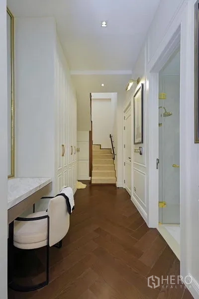 Detached House for rent or sale in Watthana, Bangkok - Hallway with built-in closets, desk nook, staircase and a shower room.