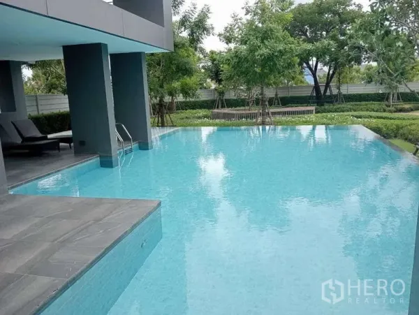 独立式住宅 出租在Bang Phli, Samut Prakan - 住区泳池，旁有花园、躺椅和遮蔽休憩区。