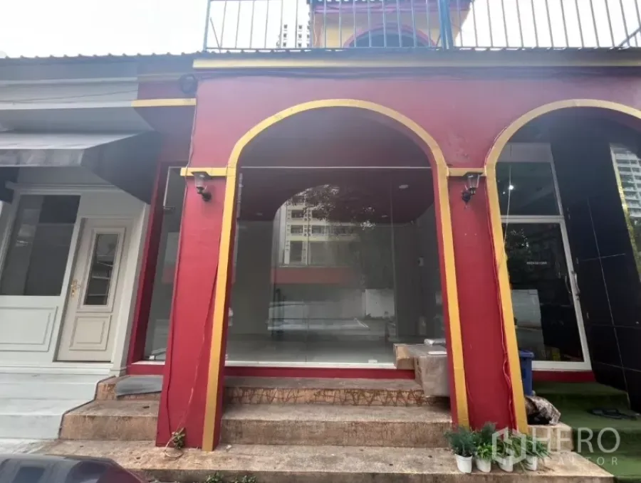 Retail Space for rent in Watthana, Bangkok - Glass-front retail storefront with red-and-gold arched facade and entry steps.
