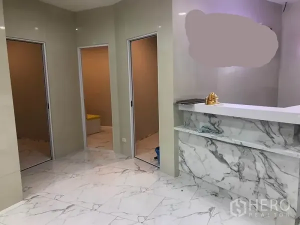 Retail Space for rent in Watthana, Bangkok - Reception counter clad in marble with three doorways leading to treatment or storage rooms.