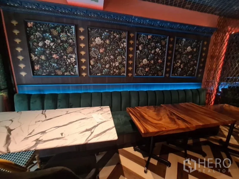Retail Space for rent in Bang Rak, Bangkok - Feature wall of floral panels with LED backlighting beside marble and wood dining tables.