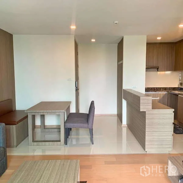 Condominium for rent - Open-plan dining nook beside a wood-toned kitchen counter.
