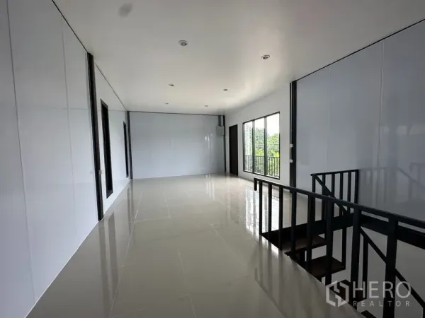 Warehouse for rent or sale in Lam Luk Ka, Pathum Thani - Bright mezzanine office with tiled floors, windows, and railing overlooking the floor.