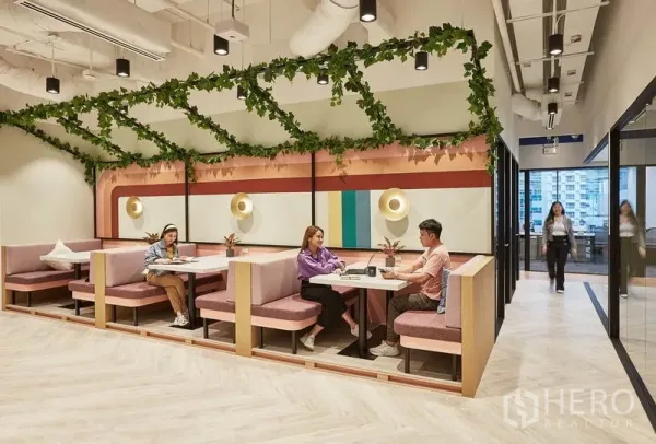 Office Space for rent in Pathum Wan, Bangkok - Colorful booth seating with greenery canopy and wall sconces in a modern office breakout area.