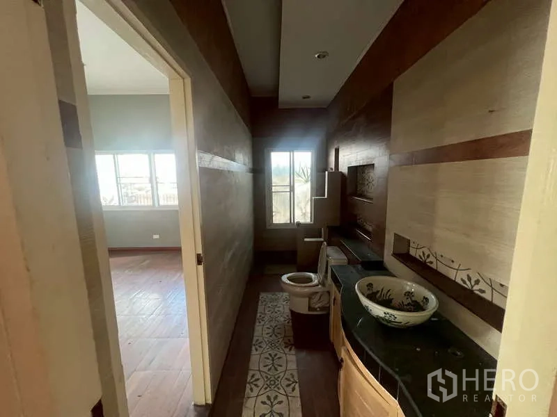 Detached House for rent in Watthana, Bangkok - Narrow bathroom with window, vessel sink and patterned tile accents.