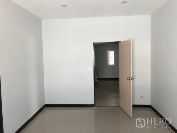Factory for rent or sale in Bang Len, Nakhon Pathom - Clean tiled office room with white walls, recessed ceiling lights and an open doorway.
