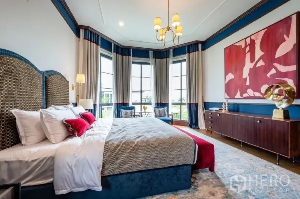 Detached House for sale in Bang Kapi, Bangkok - Elegant primary bedroom with bay windows, chandelier lighting and an upholstered headboard.
