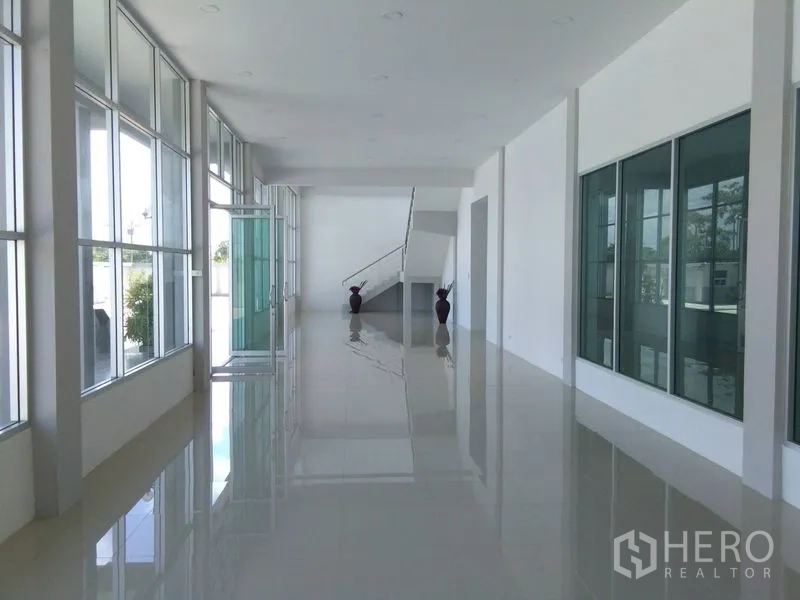 Factory for sale in Bang Sao Thong, Samut Prakan - Bright office lobby with full-height glazing and glossy tiled floors.