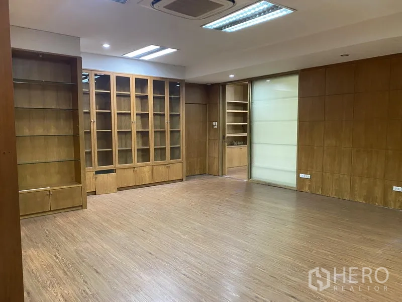Office Space for rent in Din Daeng, Bangkok - Meeting room with glass-front cabinets, sliding glass door and wood panel walls.