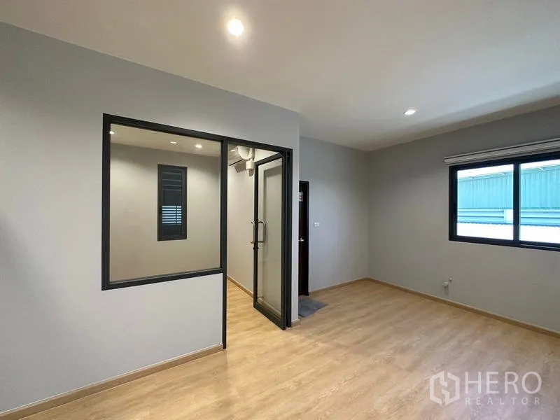 Factory for rent or sale in Lam Luk Ka, Pathum Thani - Secondary office area with internal glass room, neutral walls and natural light.