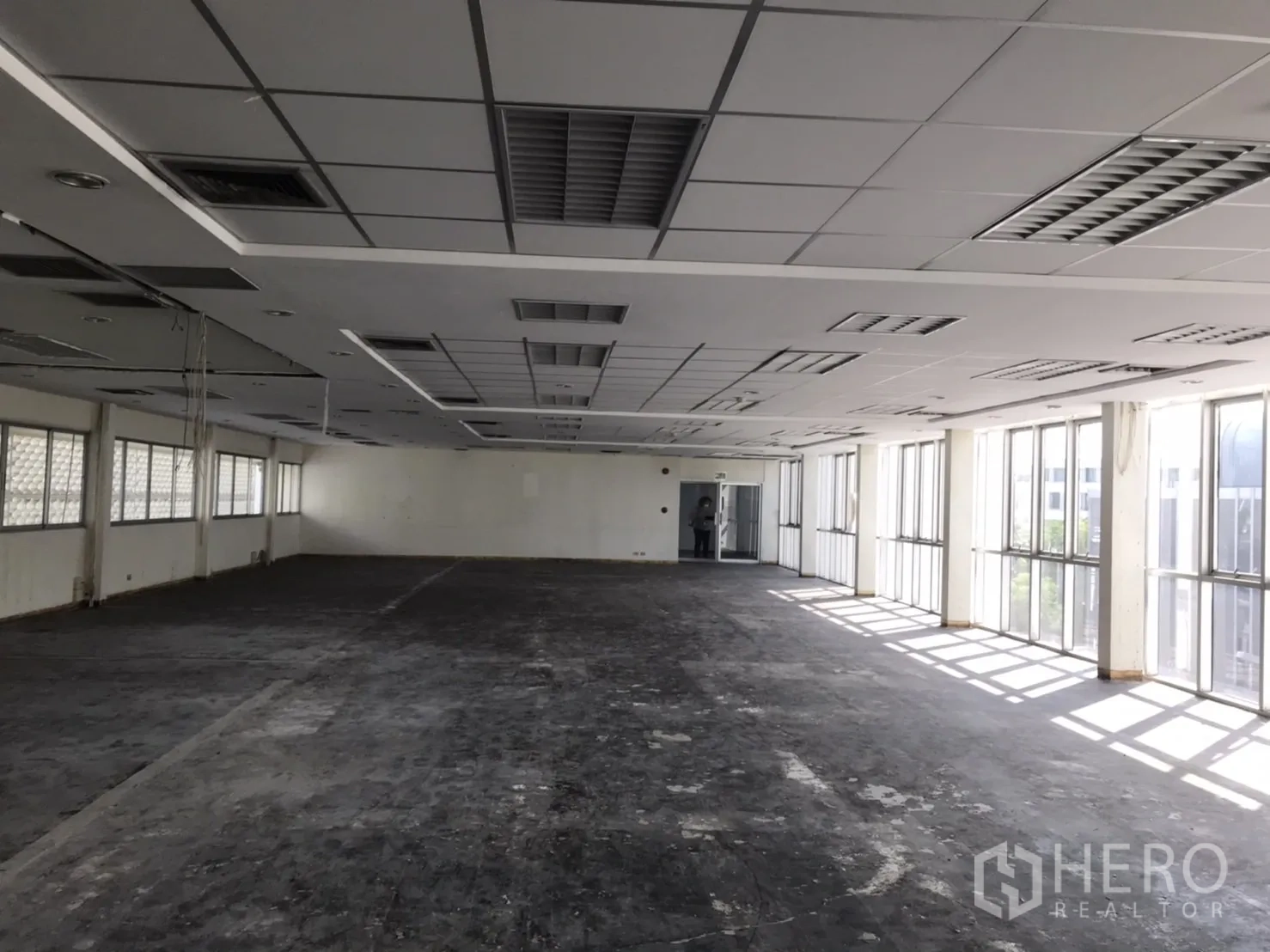 Office Space for rent in Khlong Toei, Bangkok - Open-plan 195 sqm office floor with grid ceiling, AC vents and full-height windows for natural light in Phra Khanong.