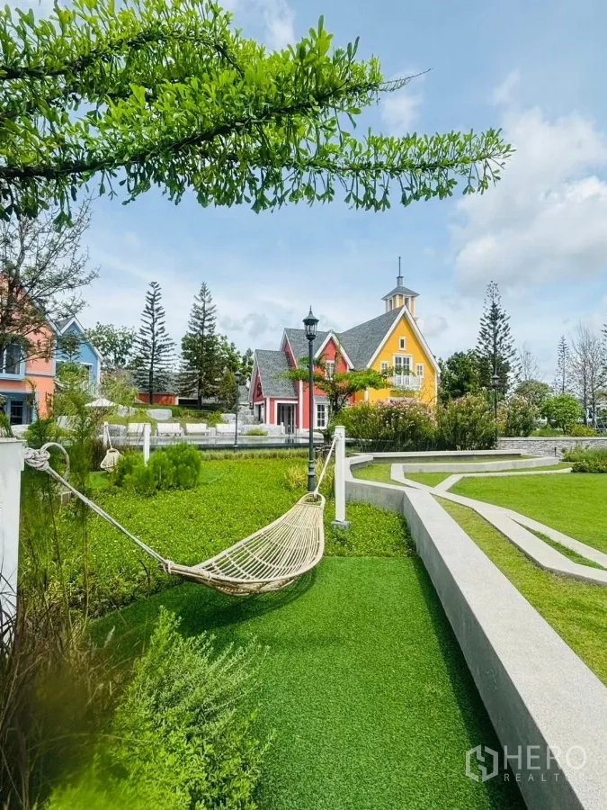 Townhouse for rent in Prawet, Bangkok - Community garden with hammock and colorful Nordic-style houses.