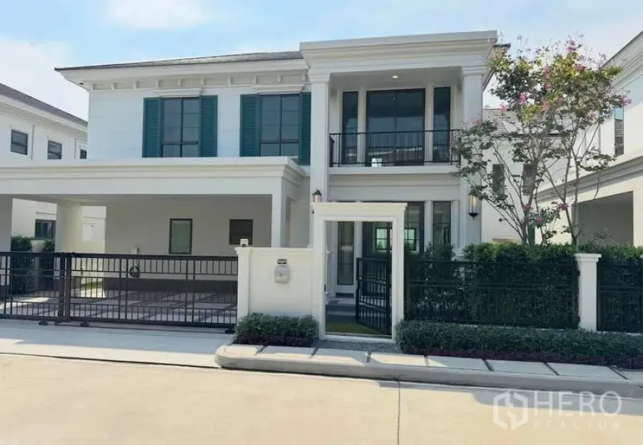 Detached House for rent in Bang Phli, Samut Prakan - Two-storey detached house exterior with gated carport, balcony and landscaped entry.