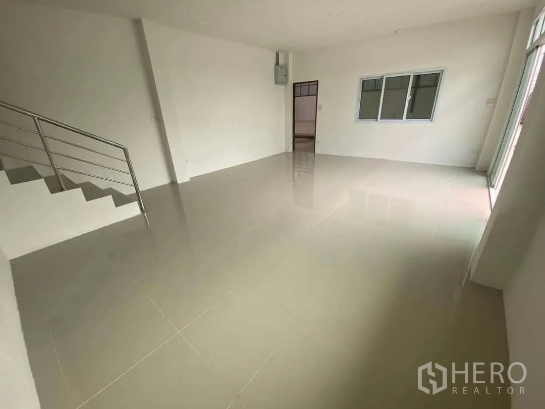 Factory for rent or sale in Mueang Samut Sakhon, Samut Sakhon - Bright office room with glossy tile flooring, staircase with stainless handrail, and large windows.